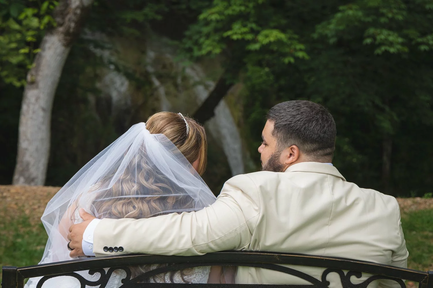 bride and groom on bench