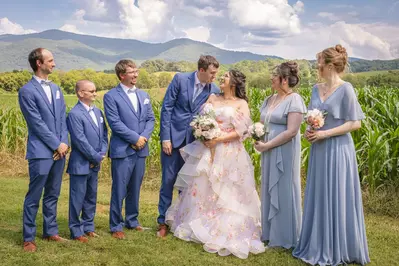 smiling bride and groom with wedding party
