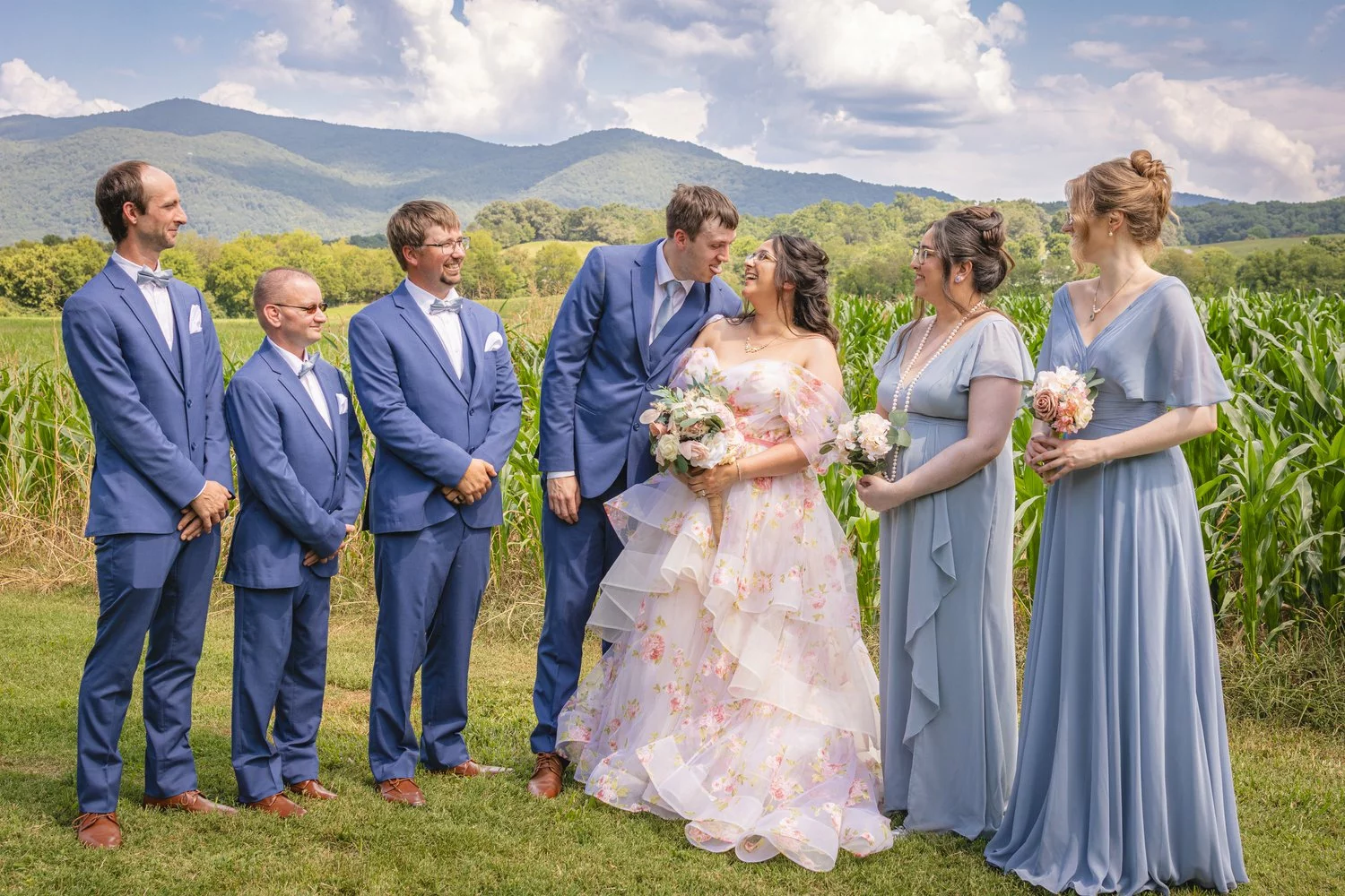 smiling bride and groom with wedding party